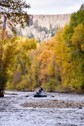 An angler casts from a boat on the Gunnison River.